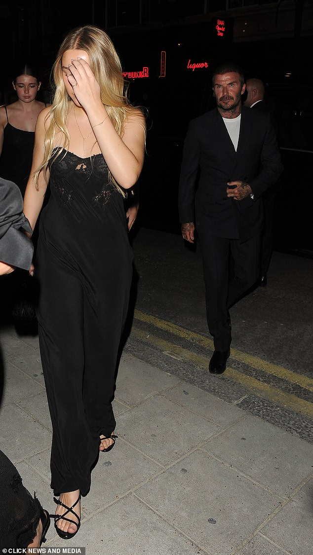 While her mini-me Harper also wore a long dress though appeared camera shy as she walked into the venue on Friday night