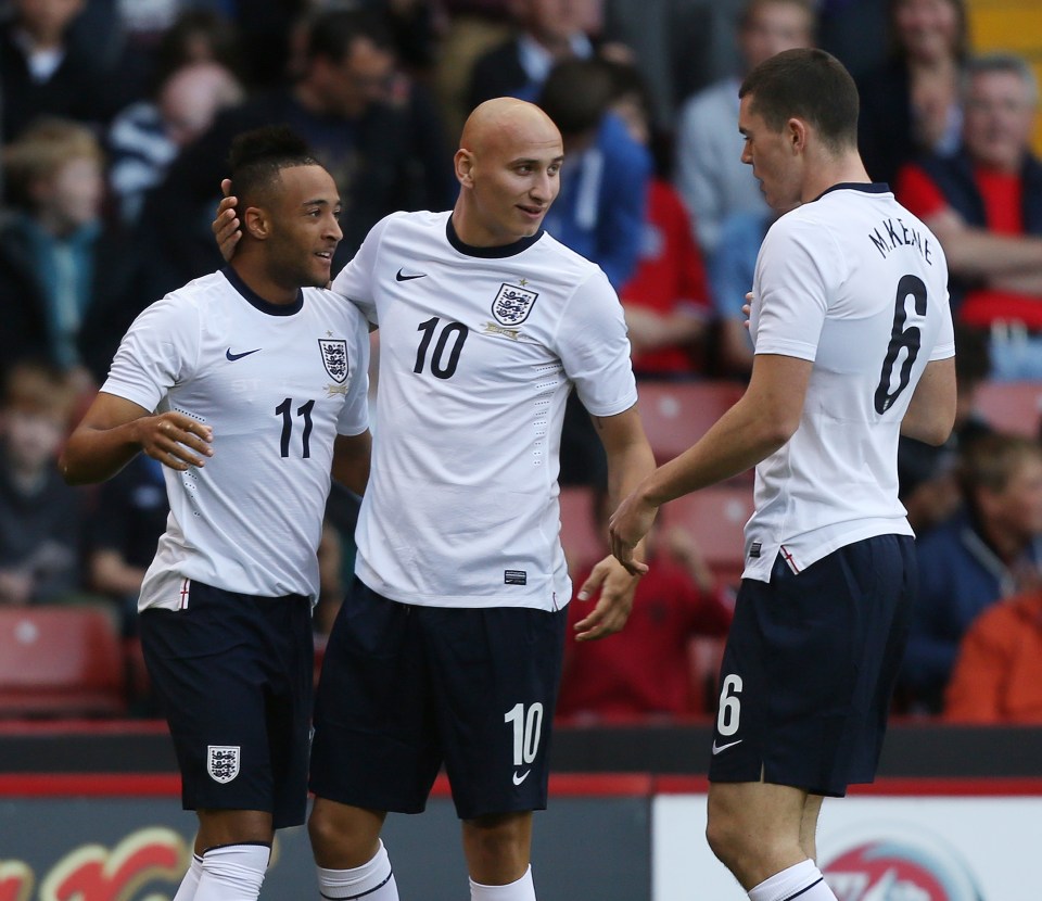 Three England under-21 soccer players celebrating.