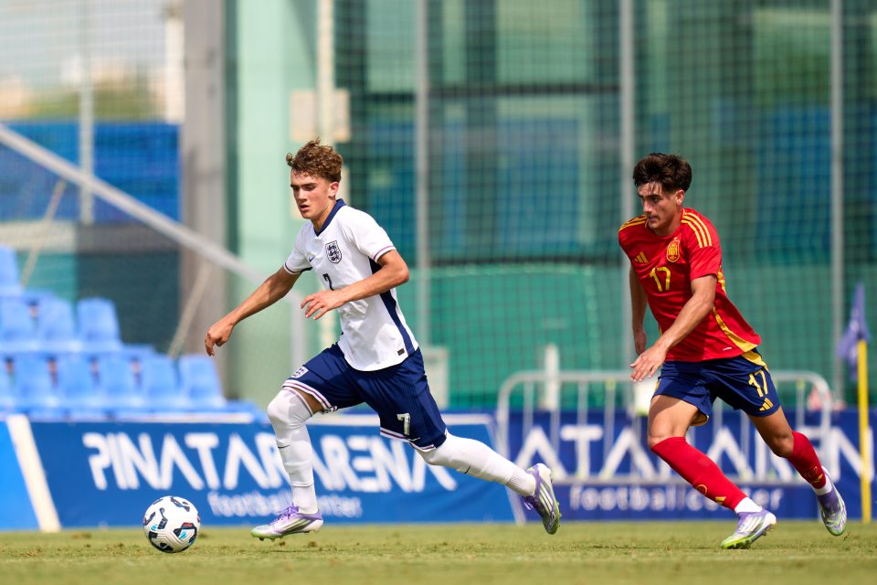 Max Dowman of England dribbling the ball past a Spain U19 player.