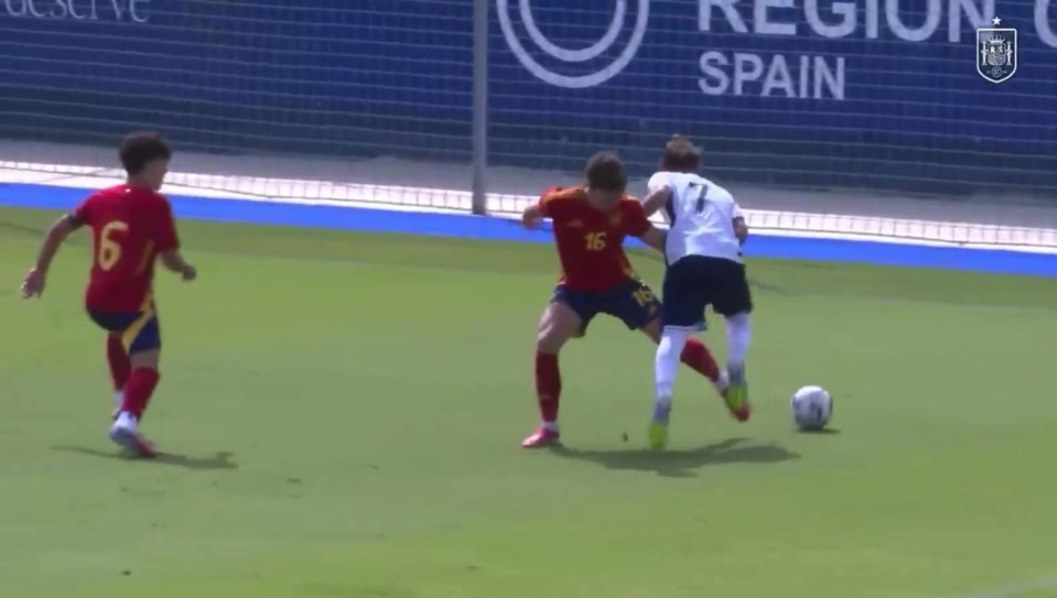 England U19 player fouled by Spain U19 player, resulting in a penalty kick.