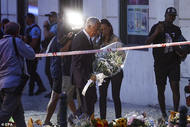 Portugal's President, Marcelo Rebelo de Sousa (C-L), pays respects to the victims of the Gloria funicular accident