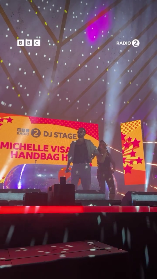 Rylan Clark and Michelle Visage performing on stage.