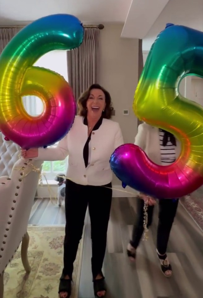 Shirley Ballas holding rainbow number balloons for her 65th birthday.