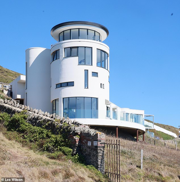 Chesil Cliff House, boasts a four-storey panoramic tower (pictured), five bedrooms, a 60ft infinity pool, a cinema, and a private beach cove, a helipad and private guesthouse