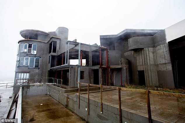 The unfinished luxury lighthouse-inspired home is pictured in 2019, years after it was granted planning permission