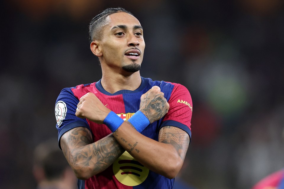 Raphinha, Barcelona's #11, celebrates scoring a goal.