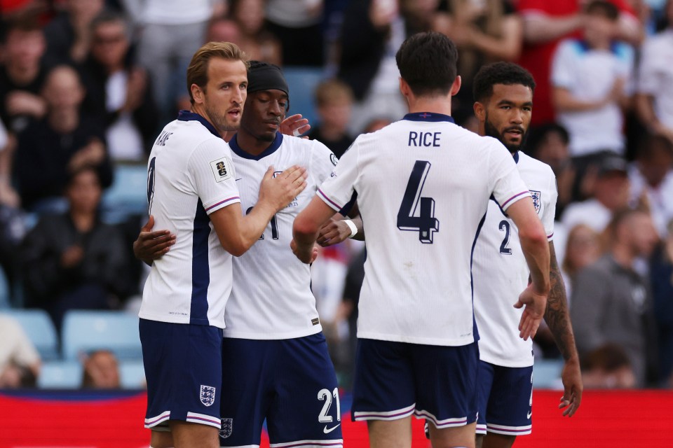 England soccer players Harry Kane and Noni Madueke celebrating a goal.