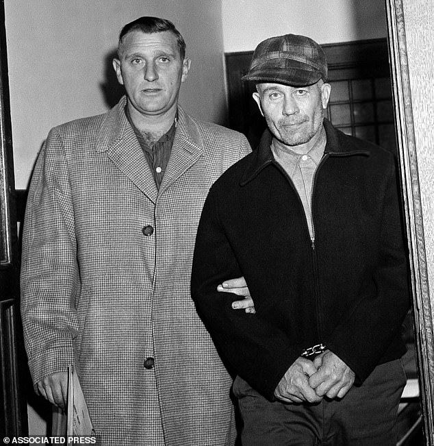 Waushara County Sheriff Art Schley, left, escorts Edward Gein, 51, of Plainfield, Wisc. into Central State Hospital for the Criminally Insane November 23, 1957, in Milwaukee
