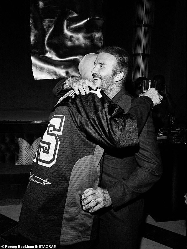Another sweet snap showed proud dad David pull his son in for a sweet hug while boasting a huge smile