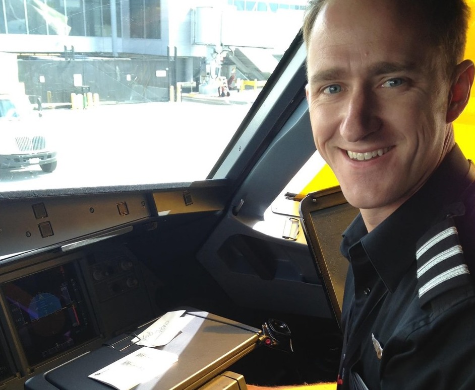 Smiling pilot in cockpit.