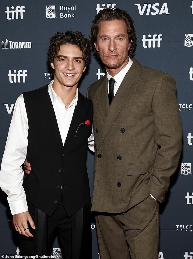 Meanwhile the Dallas Buyers Club icon looked typically smart in a buttoned-up brown suit teamed with shirt and black tie next to his lookalike son