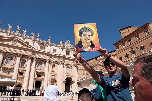 A person holds a picture of Carlo Acutis, on the day Pope Leo XIV held a general audience in St. Peter's Square, at the Vatican