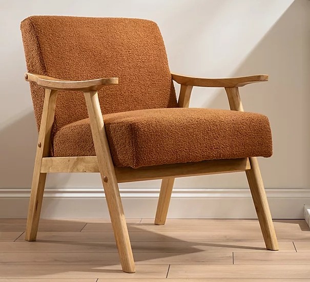 Brown boucle armchair with light wood legs.