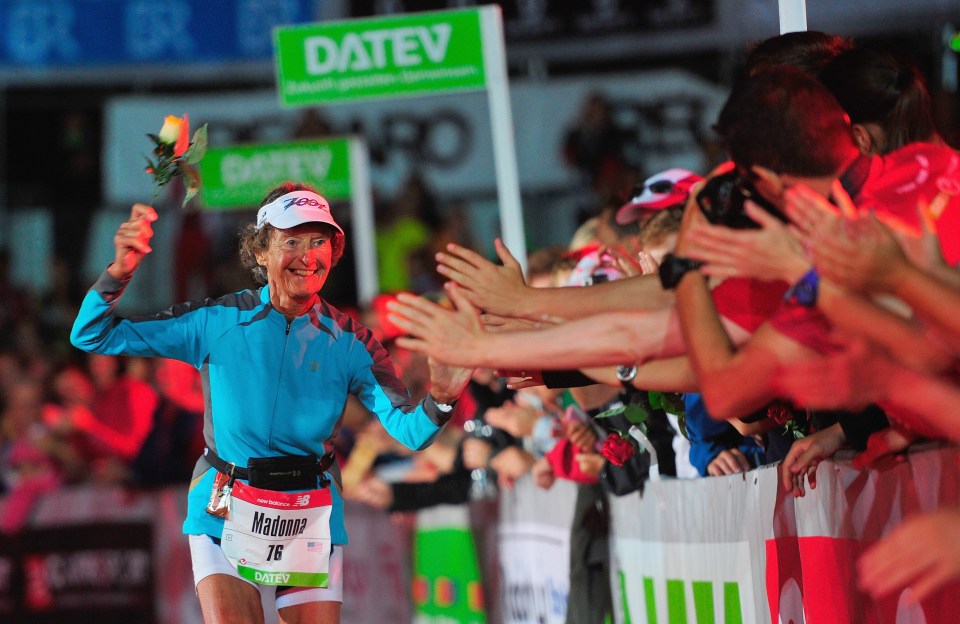 83-year-old Sister Madonna Buder finishing a triathlon, receiving congratulations.