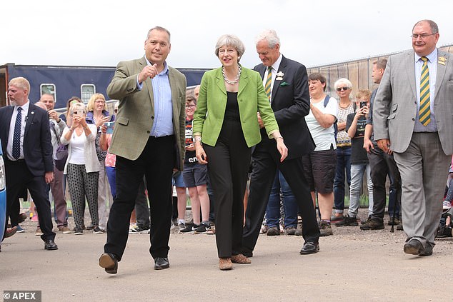 Warburton with former Prime Minister Theresa May in 2017, five years before the allegations that ended his political career