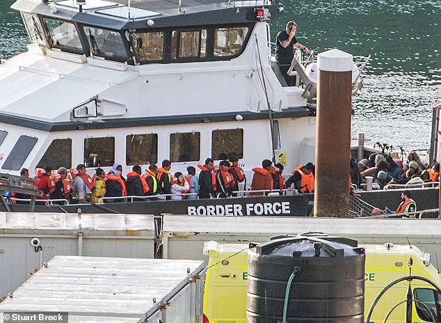 Border Force escort migrants into Dover Docks, Kent. Border Force help them ashore on AUgust 26