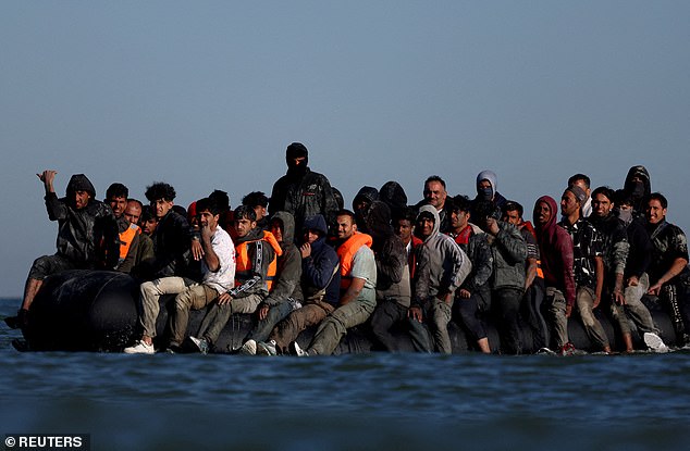A group of migrants on an inflatable dinghy leave the coast of northern France in an attempt to cross the English Channel to reach Britain