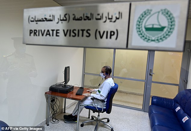 An inmate wearing protective gear receives a virtual visit at Dubai's Al-Awir central prison in the United Arab Emirates, on May 21, 2020