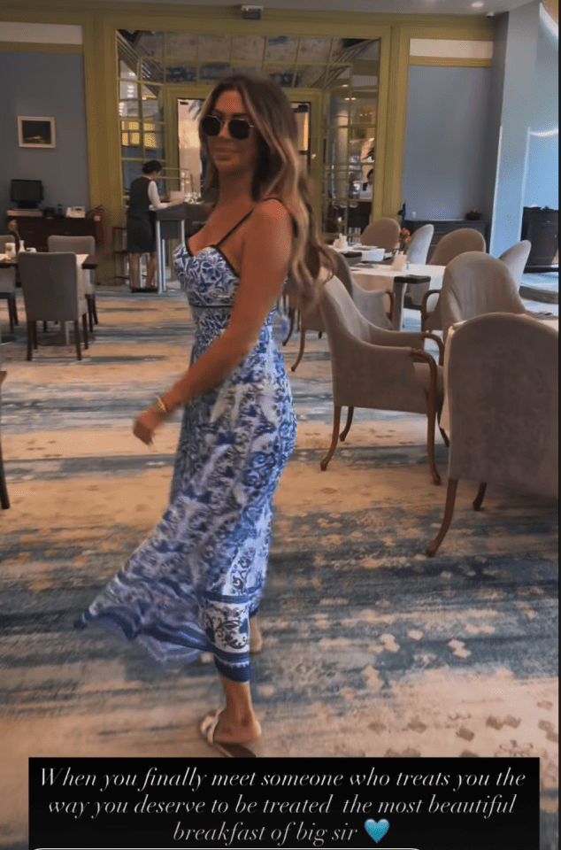 Woman in blue dress in restaurant.
