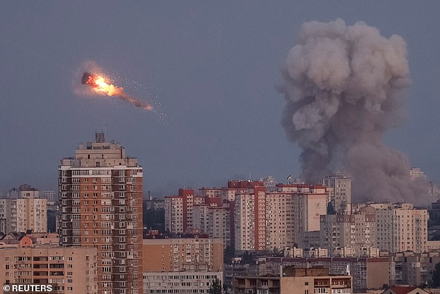 Ukrainian servicemen shoot down a Russian missile as smoke rises from Kyiv -- September 7, 2025