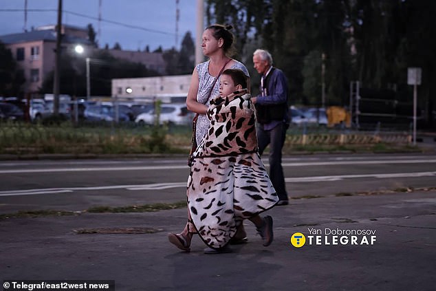 Families could be seen walking on the streets wrapped in blankets after the overnight missile attack in Kyiv -- September 7, 2025