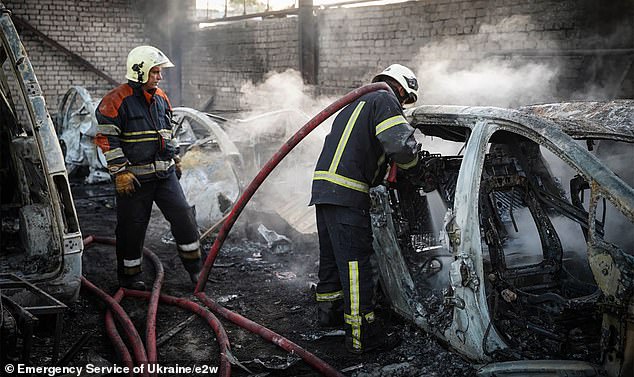 Firefighters hose down vehicles following Russia's drone attack in the Poltava region of Ukraine -- September 7, 2025