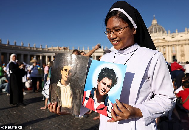 A nun holds a picture of Carlo Acutis and Pier Giorgio Frassati on the day Pope Leo XIV leads a Holy Mass for the canonisation of Carlo Acutis and Pier Giorgio Frassati, in St. Peter's Square at the Vatican, September 7, 2025