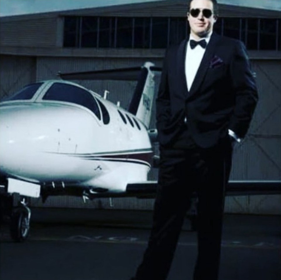Man in tuxedo standing in front of a private jet.