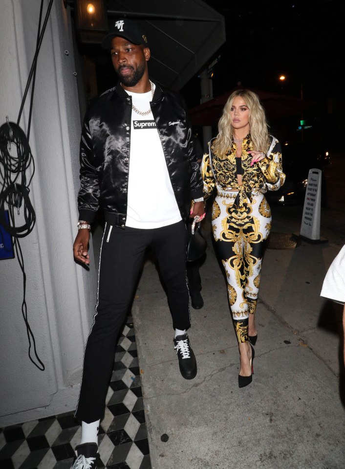 Khloe Kardashian and Tristan Thompson holding hands.