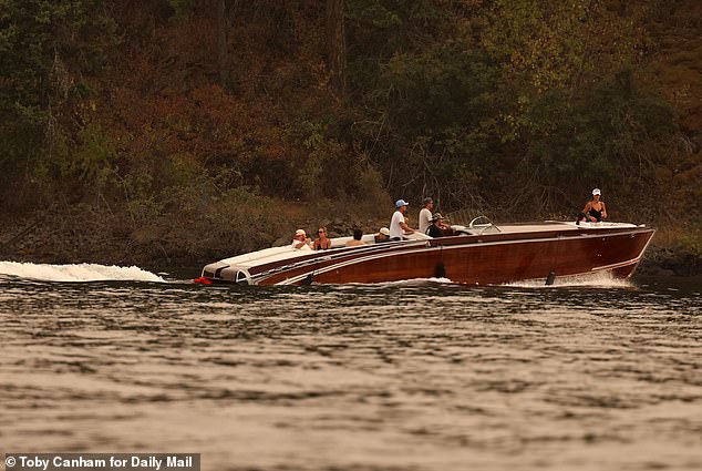 Patrick was seen getting a respite from the 89-degree heat by floating in the lake while now-wife Abby was spotted posing with a friend during a speedboat trip