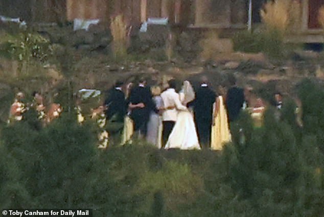 Bridesmaids were dressed in ultra-fashionable buttermilk yellow gowns while Patrick¿s 11 groomsmen wore smart black tuxedos