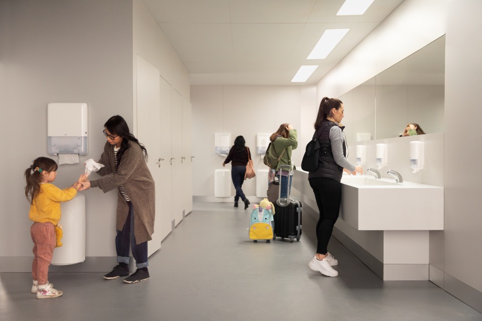 People using a clean and modern public restroom.