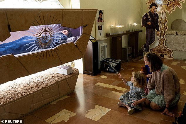 People visit the tomb of Carlo Acutis, who died of leukemia in 2006 aged 15, April 10, 2025