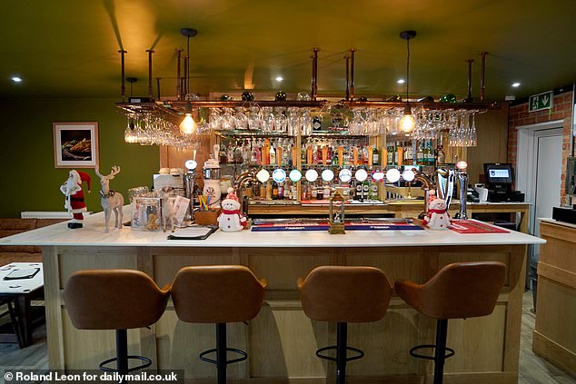 Hotel manager Minty Manhas, speaking from the cosy lounge of the adjoining £265-a-night lodge, said earlier this year the row had been 'blown out of all proportion'. Pictured: The bar at the Cask N Tandoor