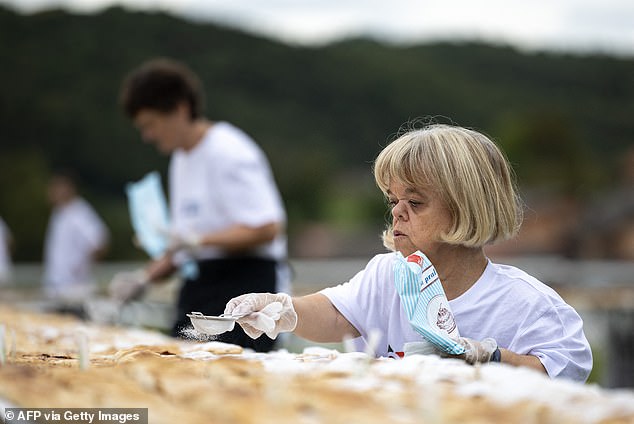 'Strudel is a symbol linked with local tradition,' said the regional mayor, Martina Furdek Hajdin, adding that these events help boost the rural region's development. Pictured: A woman sprinkles powdered sugar on the strudels