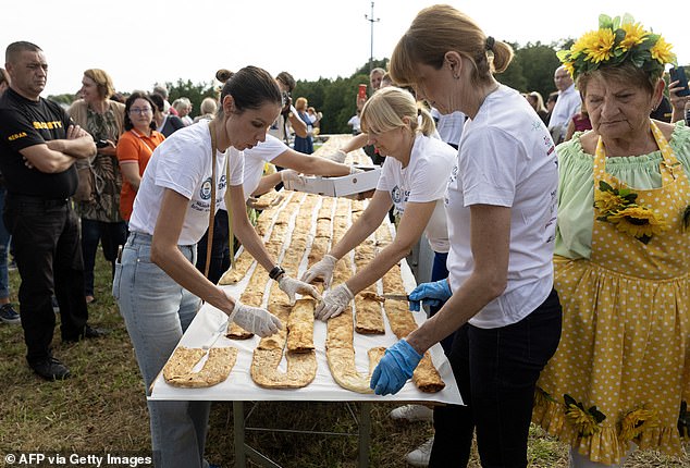 Women are seen finishing making largest strudel line in the world