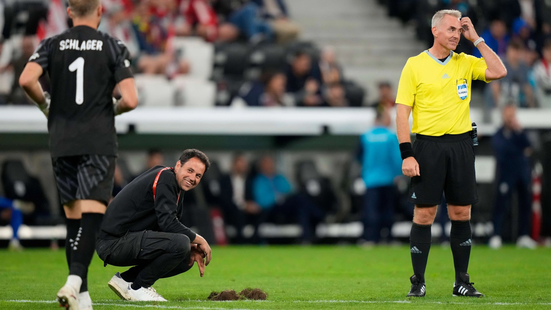 World Cup qualifier suspended as SINKHOLE opens up on pitch - before referee allows match to continue