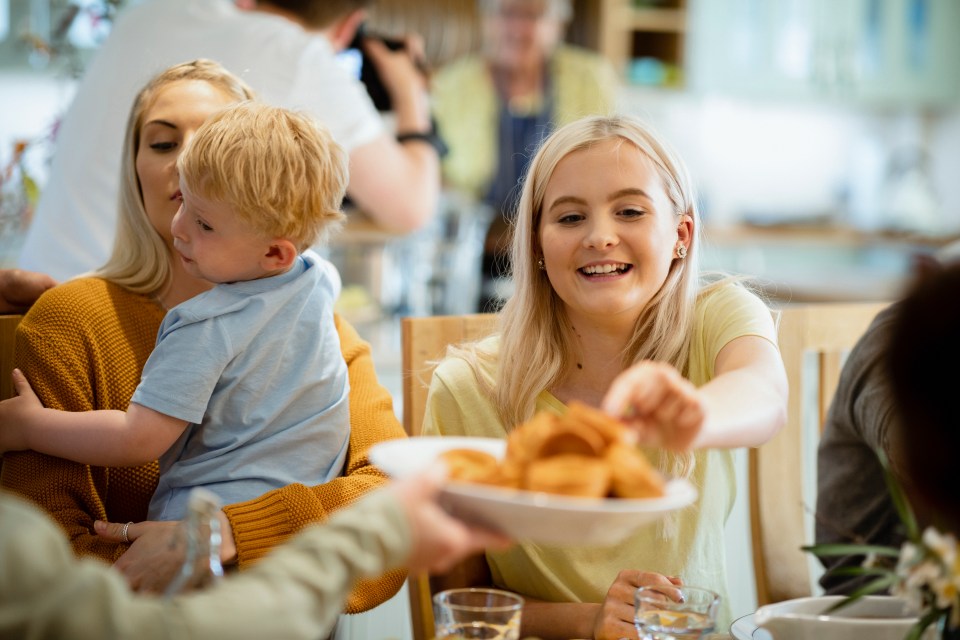 A family shares a roast dinner together.