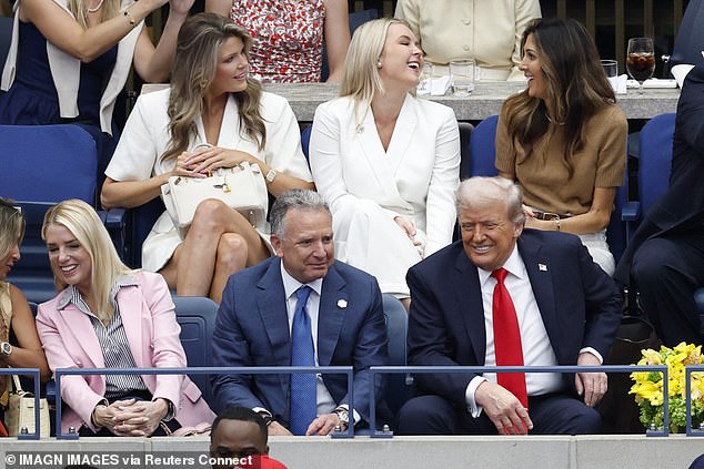 Steve Witkoff sits next to the president, while Lindsey Halligan, Karoline Leavitt, and Erin Elmore share a laugh in the row above