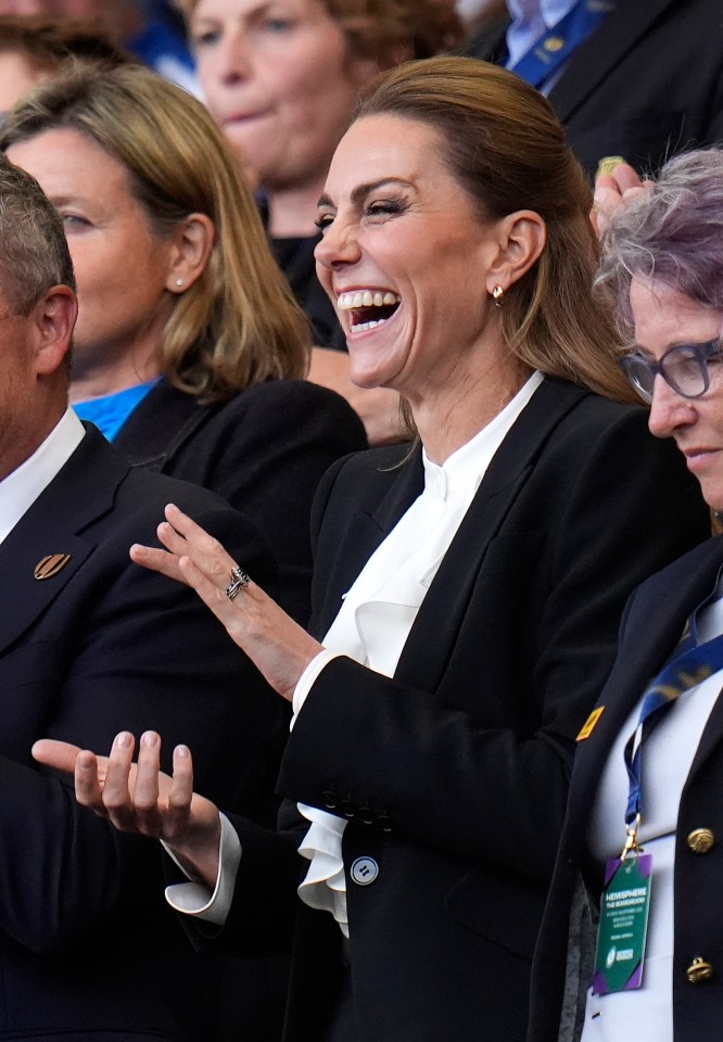 The Princess of Wales laughing in the stands at a rugby match.
