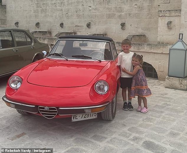 Later her younger children posed proudly next to an Italian sports car