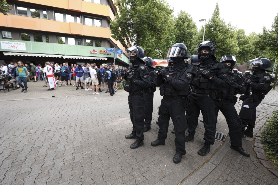Police in riot gear monitoring England fans in Gelsenkirchen, Germany.