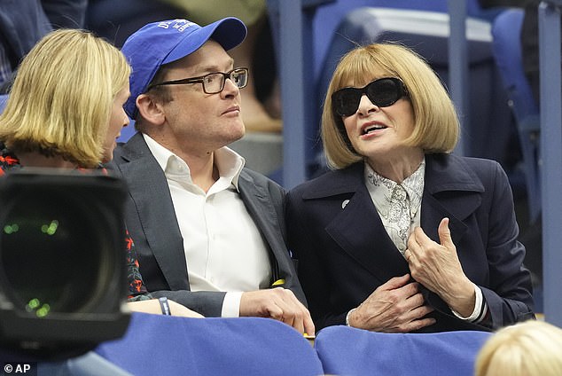 Anna Wintour, right, waits for the start of the men's singles final, which was delayed