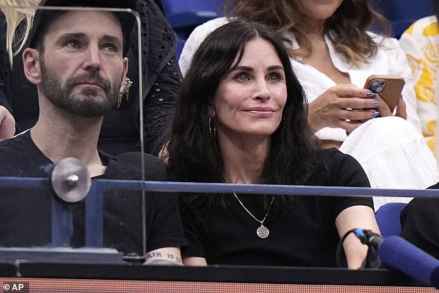 Courteney Cox watches during the women's finals of the U.S. Open tennis championships