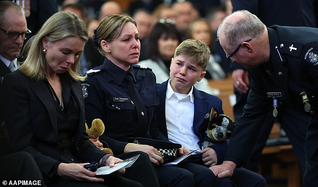 Sergeant Lisa Thompson (2L), partner of Neal Thompson, reacts during the funeral service for Detective Leading Senior Constable Neal Thompson at the Victoria Police Academy Chapel in Melbourne, Monday, September 8, 2025. (AAP Image/Con Chronis) NO ARCHIVING, POOL