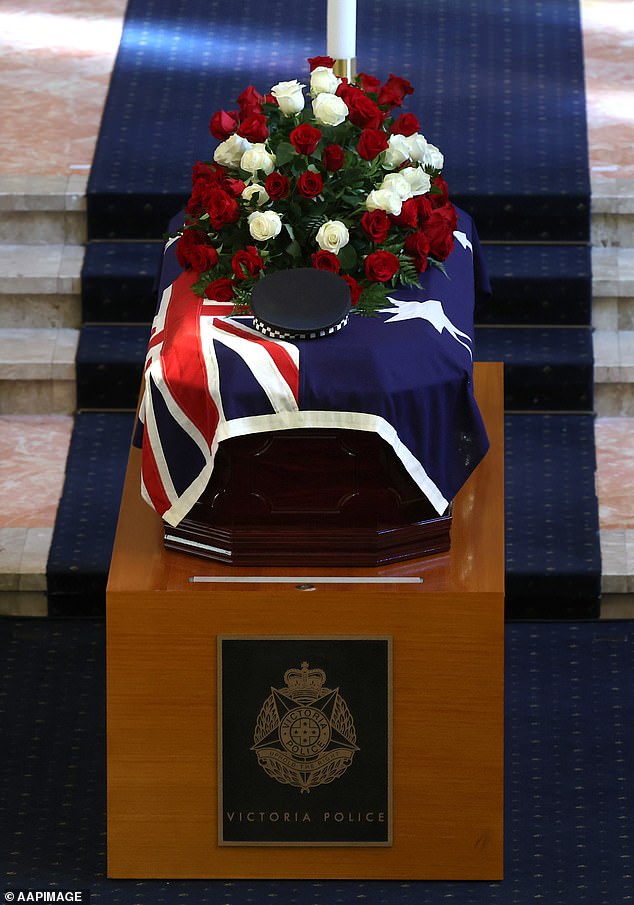 A police hat sits on casket during the funeral service for Detective Leading Senior Constable Neal Thompson at the Victoria Police Academy Chapel in Melbourne, Monday, September 8, 2025. (AAP Image/Con Chronis) NO ARCHIVING, POOL