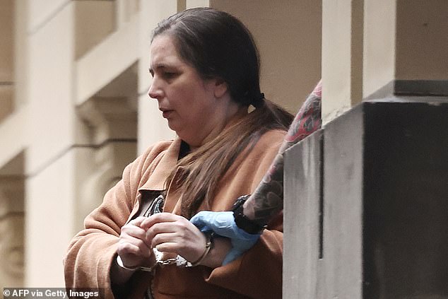TOPSHOT - Convicted murderer Erin Patterson is escorted out of the Supreme Court of Victoria following the day's proceedings in a pre-sentencing hearing in Melbourne on August 25, 2025. The only guest to survive a toxic mushroom lunch with Australian murderer Erin Patterson said August 25 he feels "half alive" without his wife -- one of the killer's three poisoning victims. Patterson, 50, was convicted in July of triple murder for serving beef Wellington laced with death cap mushrooms -- the world's deadliest fungi -- to her estranged husband's parents, aunt and uncle during a sumptuous lunch at her home in rural Leongatha in the state of Victoria in 2023. (Photo by Martin KEEP / AFP) (Photo by MARTIN KEEP/AFP via Getty Images)
