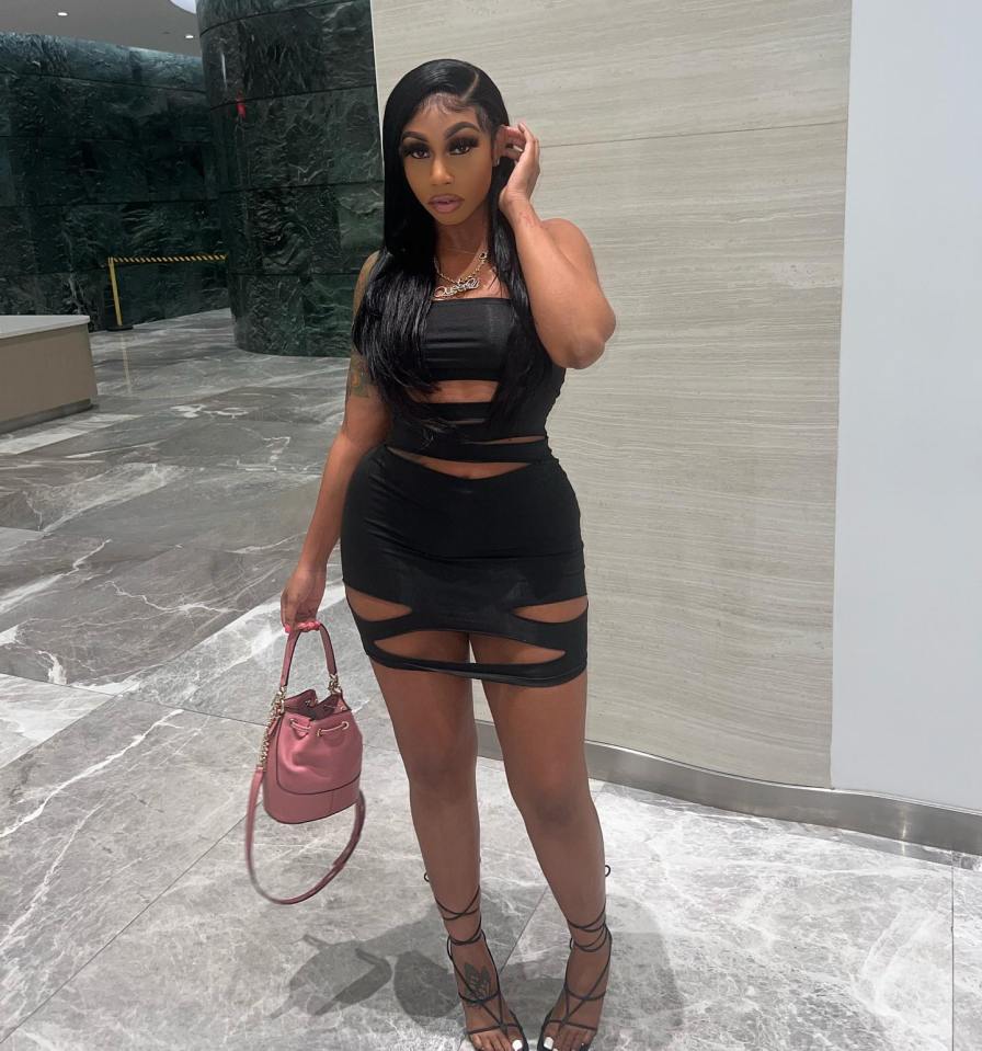 Woman in black cutout dress and heels.