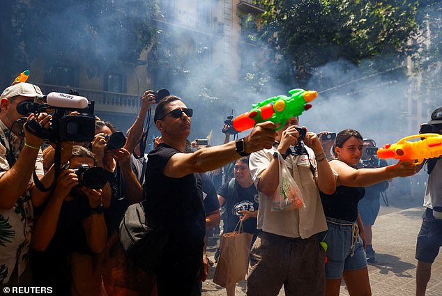 Protesters in Barcelona used water pistols to spray unsuspecting tourists in the city centre