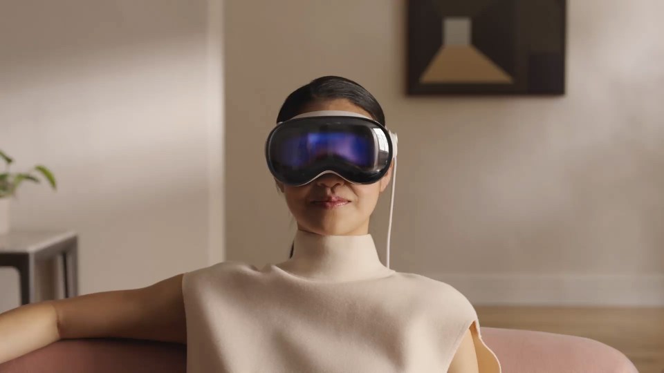Person wearing Apple Vision Pro headset.